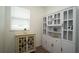 A dining area features white built-in shelving and cabinets, as well as a large window for natural light at 6367 Sw 70Th Cir, Ocala, FL 34474