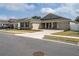 Craftsman-style home with stone accents, a well-manicured lawn, and a welcoming front porch with neighborhood view at 6367 Sw 70Th Cir, Ocala, FL 34474