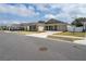 A craftsman-style home features stone accents, a well-manicured lawn, and a welcoming front porch; street view at 6367 Sw 70Th Cir, Ocala, FL 34474