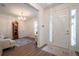 Bright foyer with hardwood floors, a vintage grandfather clock and a chandelier at 6367 Sw 70Th Cir, Ocala, FL 34474