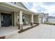 Inviting front porch with decorative stone accents, rocking chairs, and a well-manicured garden bed at 6367 Sw 70Th Cir, Ocala, FL 34474