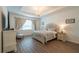 A staged main bedroom is accented by a chandelier, side tables, and a patterned bedspread at 6367 Sw 70Th Cir, Ocala, FL 34474