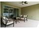 Relaxing covered patio with stylish furniture and ceiling fan, perfect for outdoor living at 6367 Sw 70Th Cir, Ocala, FL 34474