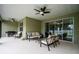 Outdoor patio with comfortable seating, ceiling fans, and sliding glass doors for seamless indoor-outdoor living at 6367 Sw 70Th Cir, Ocala, FL 34474