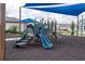 Community playground featuring a blue slide and other climbing structures on a bed of black mulch at 6367 Sw 70Th Cir, Ocala, FL 34474