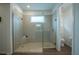 Glass-enclosed shower featuring pebble flooring, tile surround, and built-in seat at 6367 Sw 70Th Cir, Ocala, FL 34474