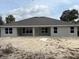 Expansive backyard featuring the home's rear facade, multiple windows, and ample space for entertainment at 6644 Sw 179Th Avenue Rd, Dunnellon, FL 34432