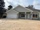 Charming single-story home features a wide two-car garage and covered entry, all with a neutral gray color scheme at 6644 Sw 179Th Avenue Rd, Dunnellon, FL 34432