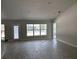 Bright and airy living room showcasing neutral walls, wood-look floors, multiple windows, and recessed lighting at 6644 Sw 179Th Avenue Rd, Dunnellon, FL 34432