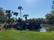 Landscaped waterfall feature with palm trees near the entrance of the community at 6644 Sw 179Th Avenue Rd, Dunnellon, FL 34432