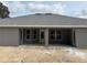 Exterior back of house featuring a covered patio and large windows providing natural light at 6698 Sw 179Th Avenue Rd, Dunnellon, FL 34432