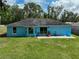 The backyard of the blue home has a patio, grassy lawn and is partially fenced in at 6950 Se 124Th Ln, Belleview, FL 34420