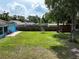 Sprawling backyard features a tall wooden fence, large shade trees, and playset at 6950 Se 124Th Ln, Belleview, FL 34420