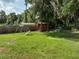 Backyard features a shed, playhouse, swing set, and privacy fence with ample green space at 6950 Se 124Th Ln, Belleview, FL 34420