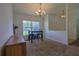 Dining room has vaulted ceilings, a chandelier, and a large window for plenty of natural light at 6950 Se 124Th Ln, Belleview, FL 34420