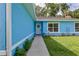 Welcoming home featuring a cheerful front door with wreath and lovely landscaping at 6950 Se 124Th Ln, Belleview, FL 34420