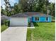 Charming single story home features a two car garage and verdant lawn with well-maintained landscaping at 6950 Se 124Th Ln, Belleview, FL 34420