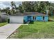 Charming single story home features a two car garage and verdant lawn with well-maintained landscaping at 6950 Se 124Th Ln, Belleview, FL 34420