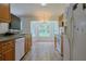 Bright kitchen features white appliances, tile flooring, and a breakfast nook with bay window at 6950 Se 124Th Ln, Belleview, FL 34420