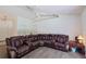 Spacious living room features a sectional sofa, ceiling fan, and neutral carpeting at 6950 Se 124Th Ln, Belleview, FL 34420