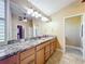 Bathroom featuring granite countertops, double sinks, and ample storage space at 7688 Se 135Th St, Summerfield, FL 34491