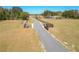 Long driveway leading to the house on a rural property, bordered by wood fence at 7688 Se 135Th St, Summerfield, FL 34491