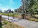 Gated driveway to expansive property with mature trees and lush pastures at 7688 Se 135Th St, Summerfield, FL 34491