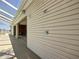 Exterior of home showcasing covered outdoor grilling area attached to screened pool at 7688 Se 135Th St, Summerfield, FL 34491