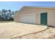 Spacious garage with roll-up door and convenient side entrance, offering ample parking at 7688 Se 135Th St, Summerfield, FL 34491