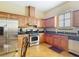 This kitchen features stainless steel appliances and custom wood cabinets at 7688 Se 135Th St, Summerfield, FL 34491