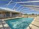 Backyard pool enclosed with a screened cage and attached to the home at 7688 Se 135Th St, Summerfield, FL 34491