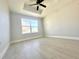 Spacious bedroom with a window letting in natural light and luxury vinyl plank flooring at 8295 Se 159Th Ln, Summerfield, FL 34491