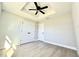 Bright bedroom featuring a trey ceiling with ceiling fan and luxury vinyl plank flooring at 8295 Se 159Th Ln, Summerfield, FL 34491