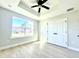 Well-lit bedroom with a window and a closet featuring double doors and luxury vinyl plank flooring at 8295 Se 159Th Ln, Summerfield, FL 34491