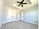 Bedroom featuring a trey ceiling, ceiling fan, closet and luxury vinyl plank flooring at 8295 Se 159Th Ln, Summerfield, FL 34491