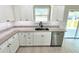 Modern kitchen featuring white cabinets, granite countertops, and stainless steel dishwasher at 8295 Se 159Th Ln, Summerfield, FL 34491