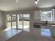 Kitchen featuring stainless steel appliances, white cabinets, and granite countertops with sliding glass doors at 8295 Se 159Th Ln, Summerfield, FL 34491