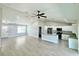 Open-concept living space with a kitchen featuring white cabinets and stainless steel appliances at 8295 Se 159Th Ln, Summerfield, FL 34491