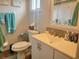 Clean bathroom featuring a vanity with white cabinetry, a toilet, and a shower at 8481 Sw 107Th Pl, Ocala, FL 34481