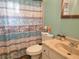 Cozy bathroom features a marble sink and a patterned shower curtain at 8481 Sw 107Th Pl, Ocala, FL 34481