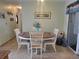 Bright dining room featuring tile flooring, a wooden table, and four chairs at 8481 Sw 107Th Pl, Ocala, FL 34481