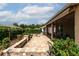 Relax on this home's brick-paved back patio with screened-in porch, complete with a cozy fire pit and lush landscaping at 8532 Sw 79Th Ave, Ocala, FL 34481