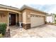 Close-up of the front entrance featuring a dark wooden door, decorative stone accents, and a paver walkway at 8532 Sw 79Th Ave, Ocala, FL 34481