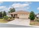 Inviting single-story house boasts a landscaped front yard and a spacious two-car garage with decorative windows at 8532 Sw 79Th Ave, Ocala, FL 34481