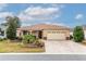 Charming single-story home featuring a well-manicured lawn and a two-car garage with stylish stone accents at 8532 Sw 79Th Ave, Ocala, FL 34481