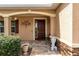 Inviting front porch with dark wood door, stylish stone accents, and elegant decorative details at 8532 Sw 79Th Ave, Ocala, FL 34481