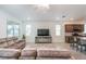 Bright living room with cozy sofas, a large TV, and an open layout to the kitchen area at 8532 Sw 79Th Ave, Ocala, FL 34481