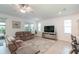 Inviting living room featuring comfortable sofas, a ceiling fan, and large windows for natural light at 8532 Sw 79Th Ave, Ocala, FL 34481