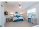 Serene main bedroom with a ceiling fan, large window, and a light blue and white color scheme at 8532 Sw 79Th Ave, Ocala, FL 34481