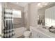 Bright bathroom with a shower-tub combo, grey tile, new fixtures, and single sink vanity at 8874 Sw 104Th Cir, Ocala, FL 34481